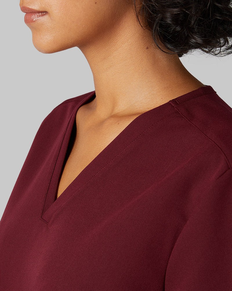 32 Degrees Burgundy _ Women's 2-Pocket V-Neck scrub Top {model: Arantza is 5'9"and size 2 wearing size XS}{bottom}{right} {bottom}{right}